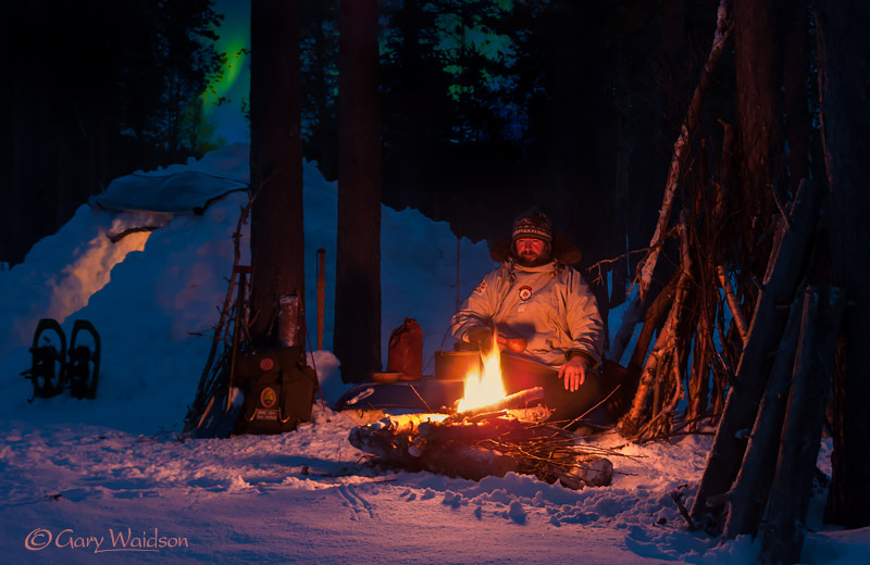 A Quinzhee and campfire under the Northern Lights in the Boreal forest. -  2017 - Gary Waidson - Ravenlore